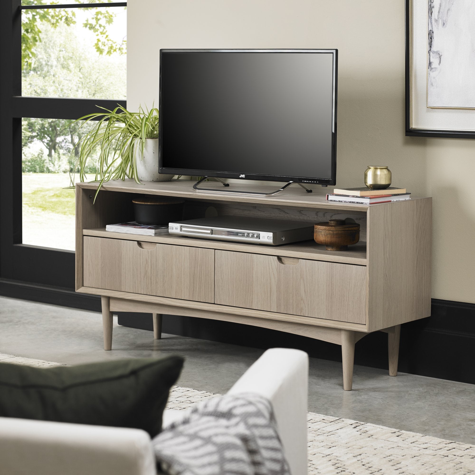 Oak veneer entertainment unit with solid beech legs in light oak finish
