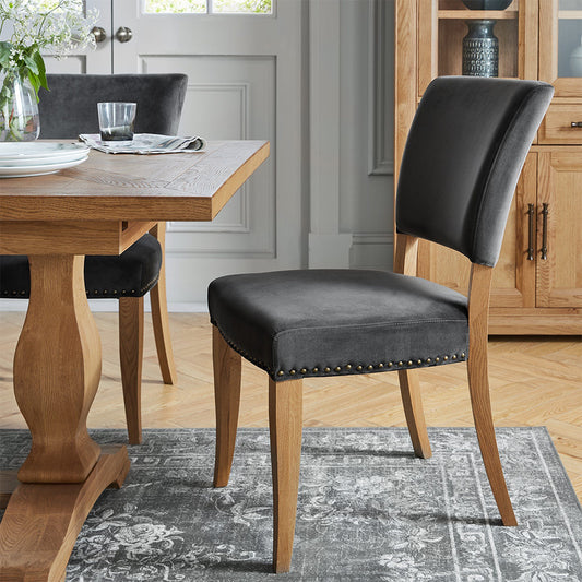 Dining chair upholstered in black velvet with wooden legs