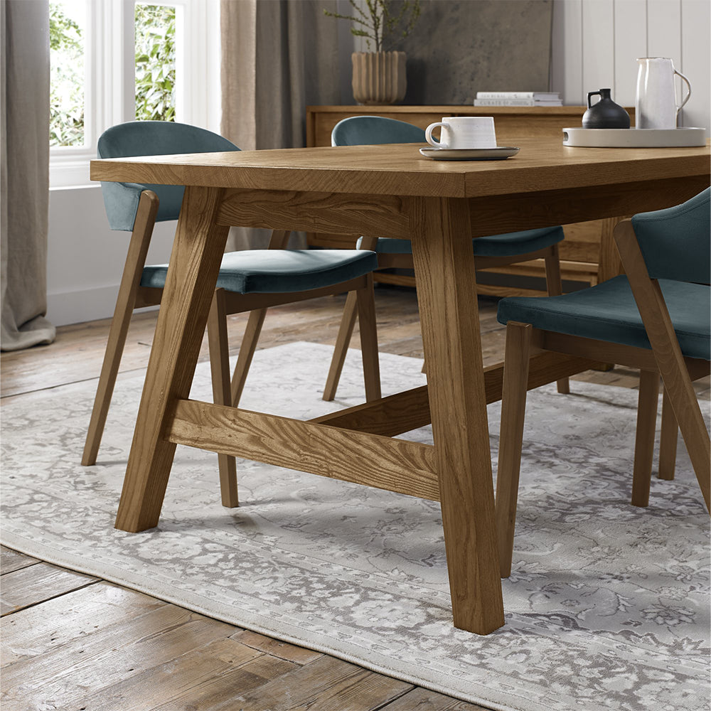 Rustic oak extending dining table with laminated oak tabletops and solid ash legs all in natural finish
