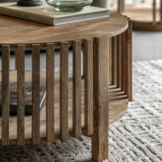 Slatted wooden coffee table in natural finish with lower storage shelf