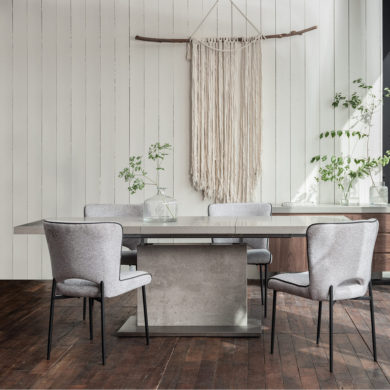 Neutral grey toned stone effect extending dining table set upon matching solid base