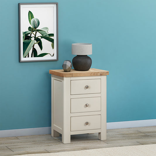 Painted off-white 3 drawer bedside cabinet with natural wood top and three drawers
