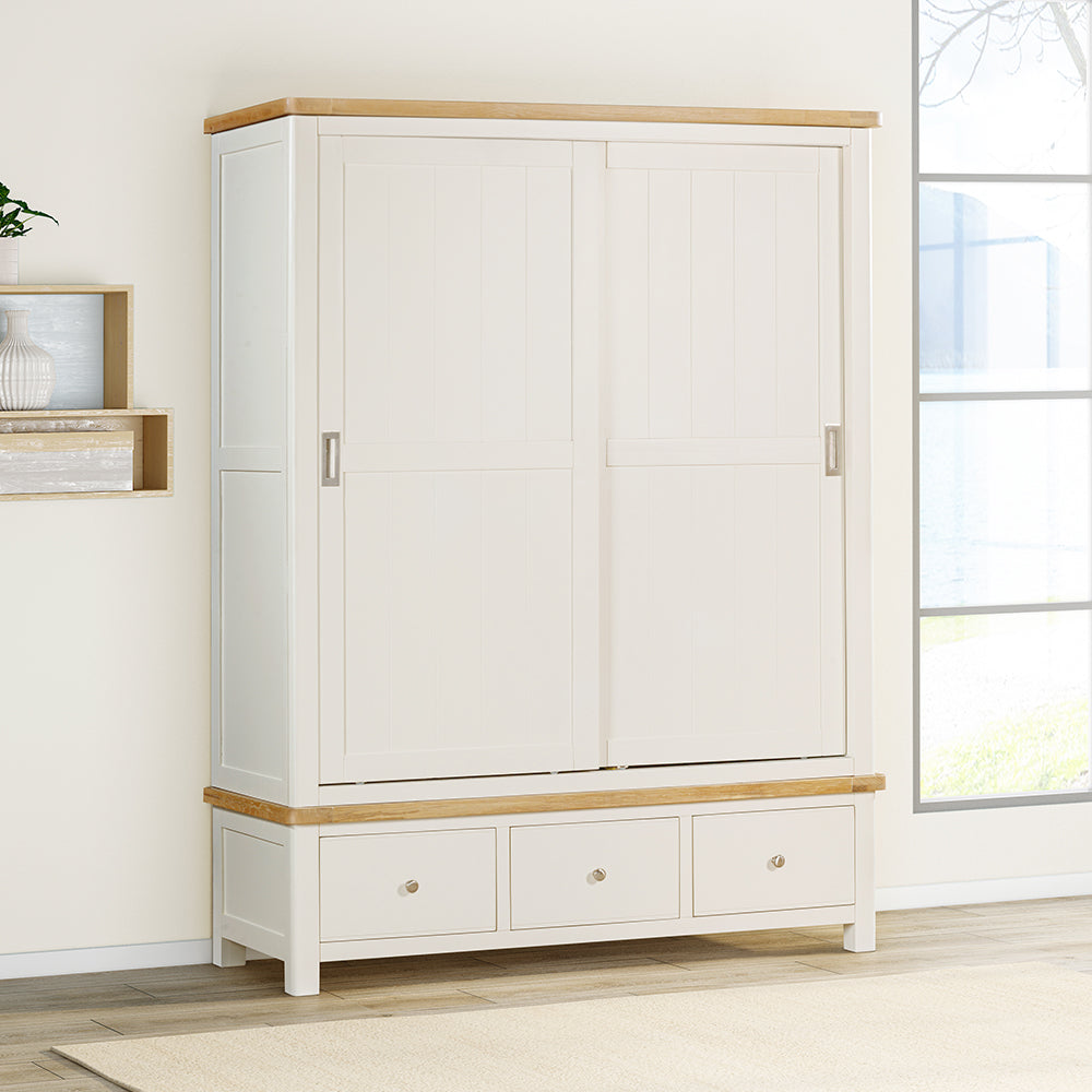 Painted off-white 3 drawer wardrobe, natural wood trim and sleek, silver draw and door handles
