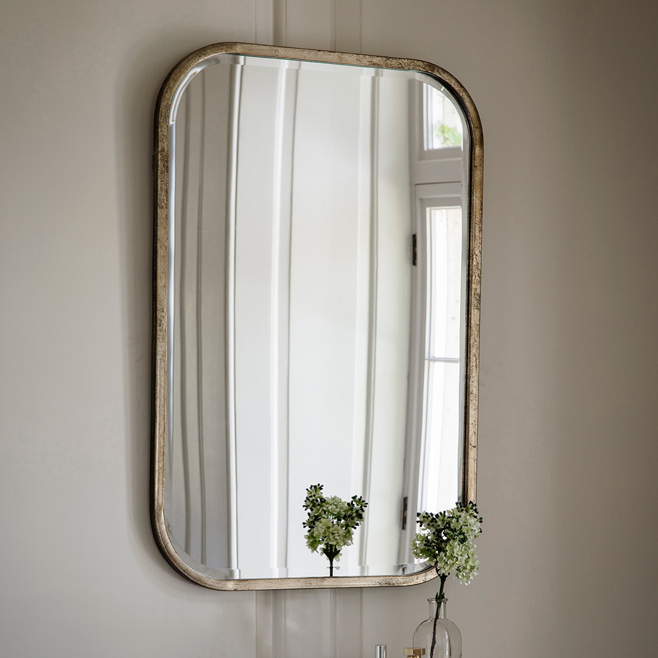 Curved mirror in champagne finish