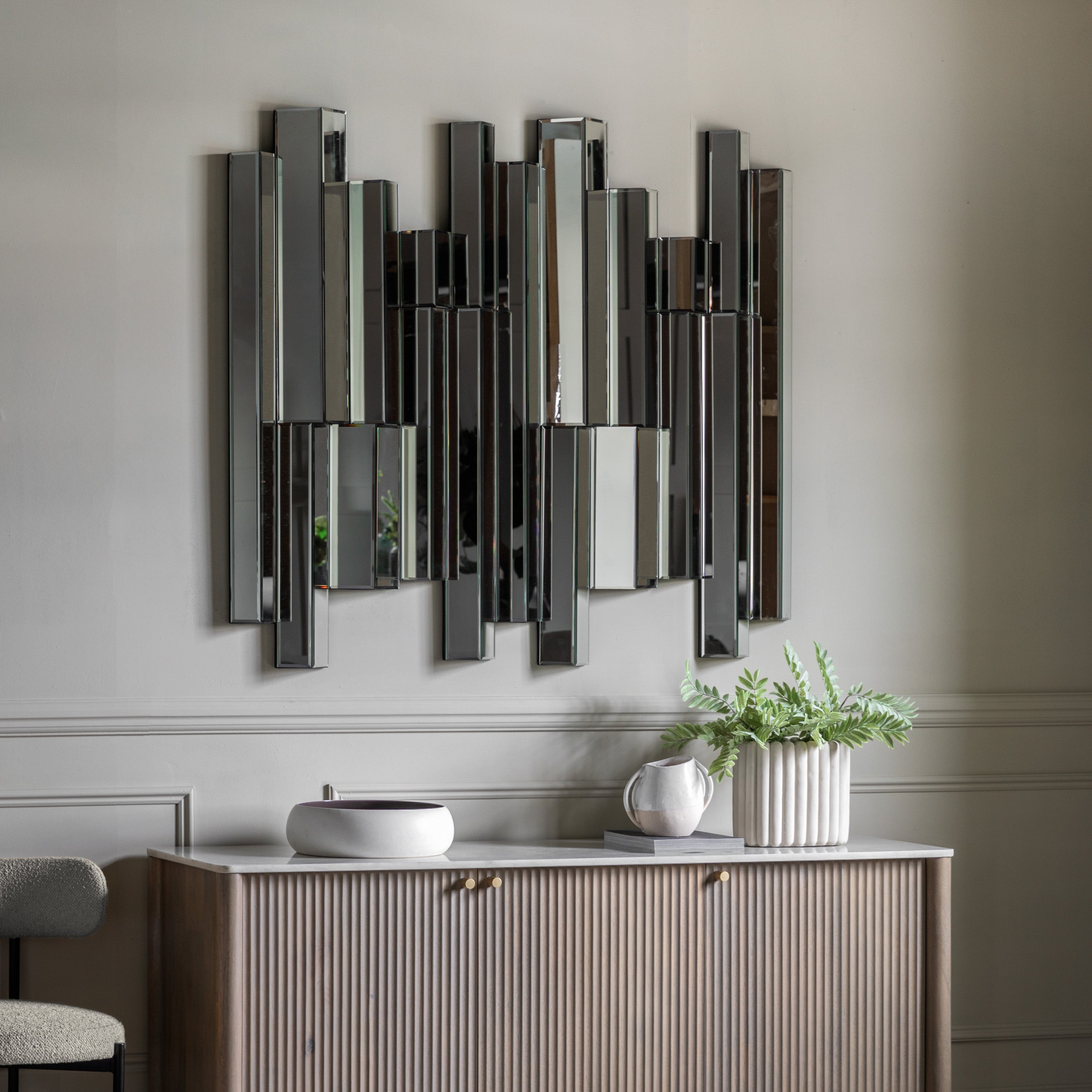 Modern wall mirror with abstract bevelled panelling