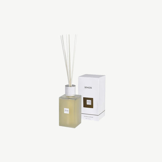 Reed diffuser in clear glass bottle with white reeds