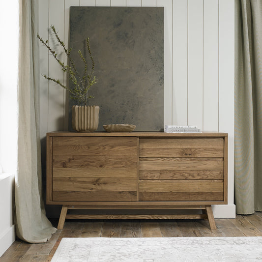 Rustic oak wide sideboard with laminated oak top and solid ash legs all in natural finish
