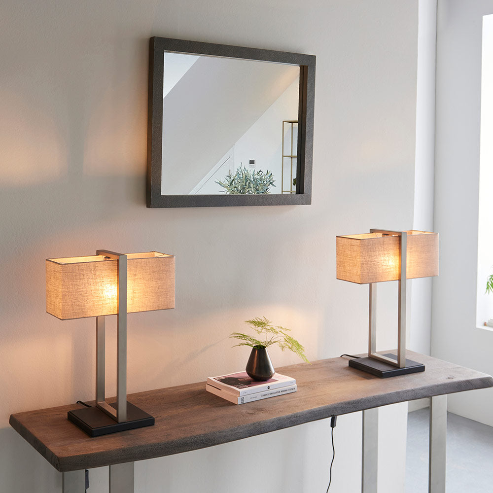 Modern table lamp with matt black base, satin nickel finished frame and linen shade