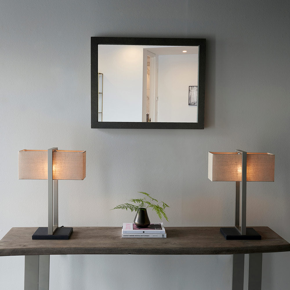 Modern table lamp with matt black base, satin nickel finished frame and linen shade