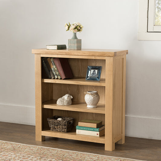 Oak low bookcase in natural finish with three shelves