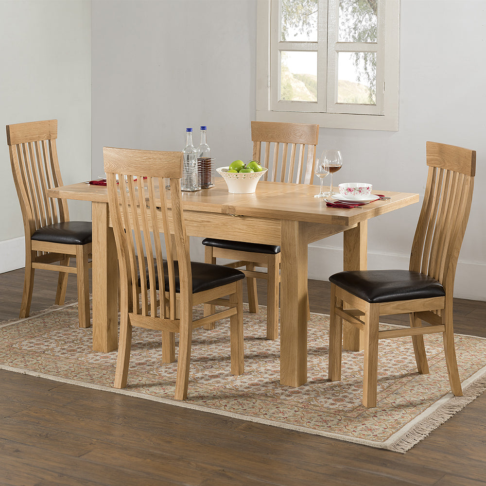 Oak extending dining table in natural finish with four leg base