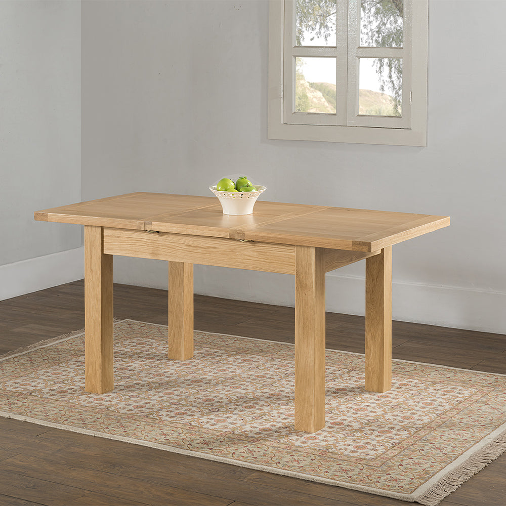 Oak extending dining table in natural finish with four leg base