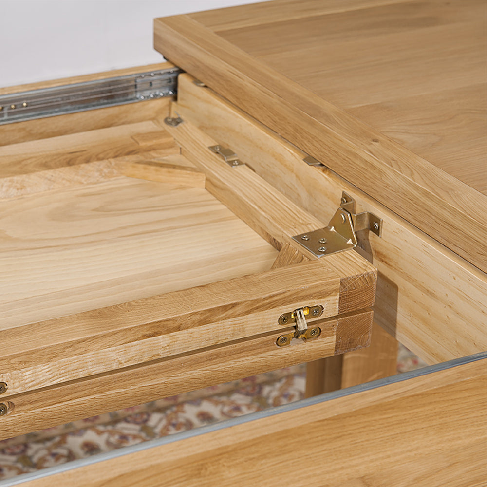 Oak extending dining table in natural finish with four leg base