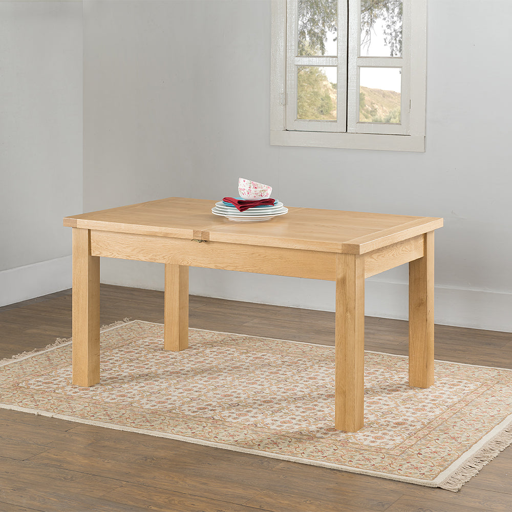 Oak extending dining table in natural finish with four leg base