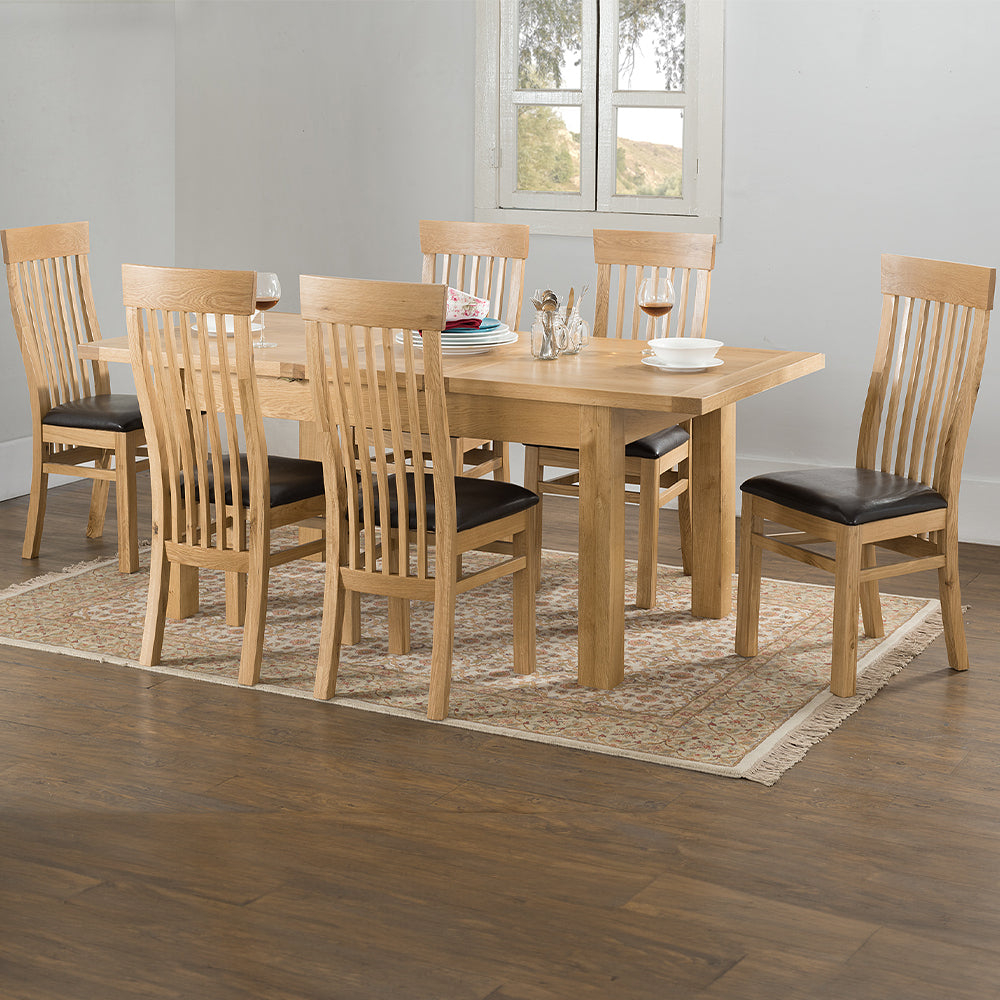 Oak extending dining table in natural finish with four leg base