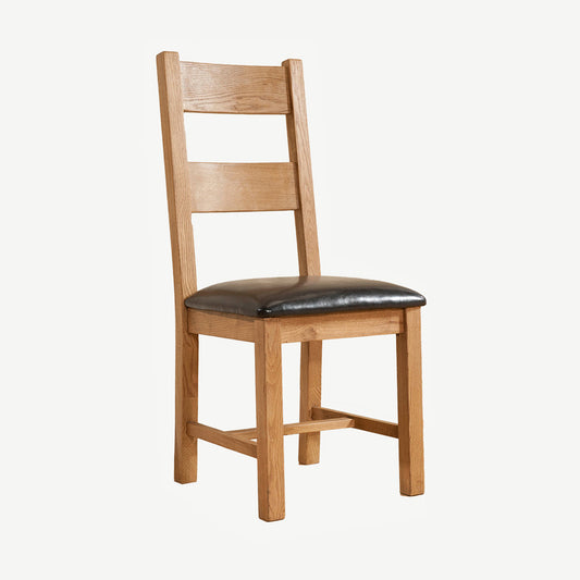 Solid wood dining chair in natural oak finish with dark faux leather seat